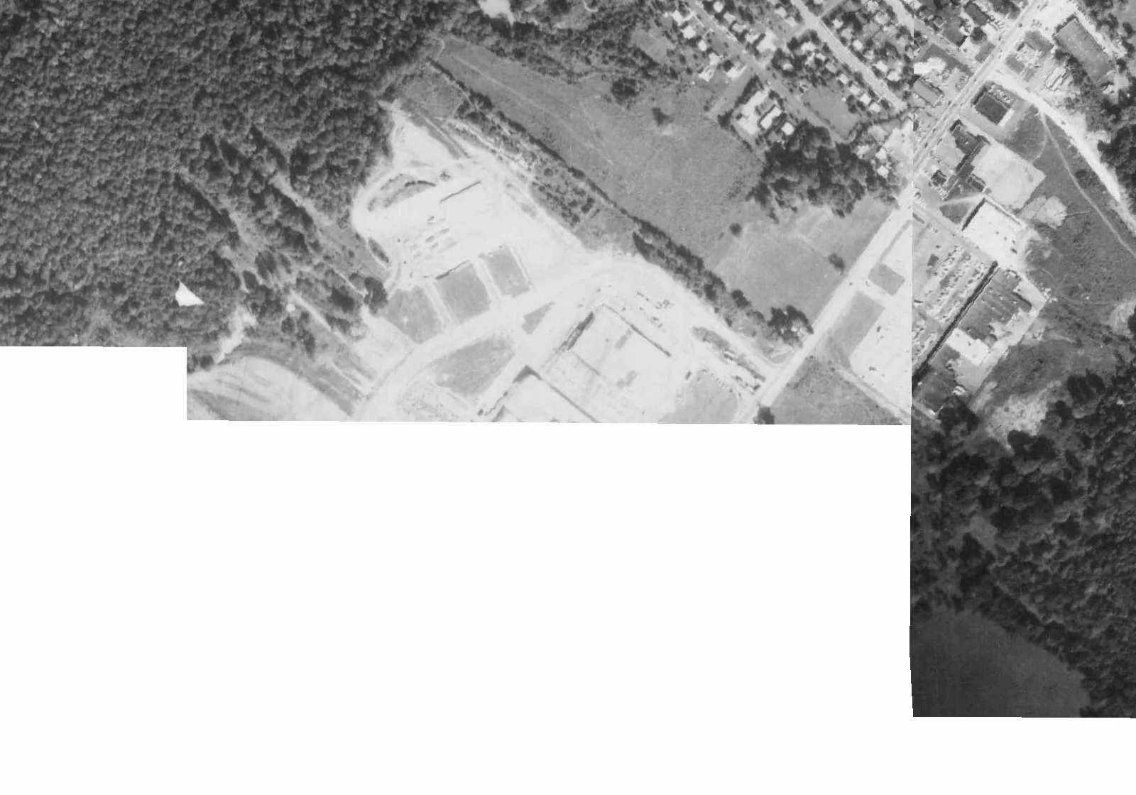 1971 aerial photo showing the racing oval gone and building pads graded for construction, with part of the frame blank where the county mosaic has no coverage