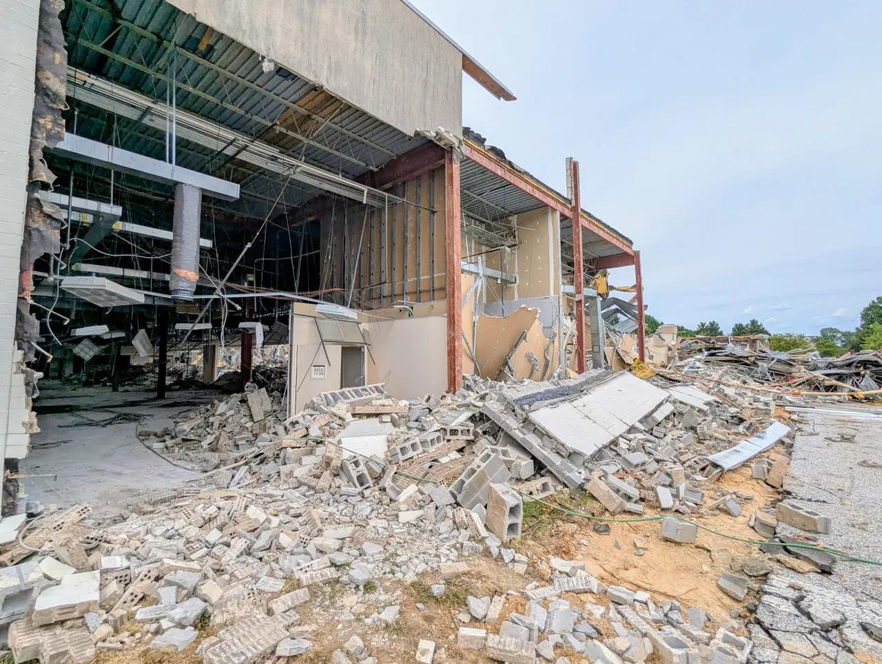 Exposed steel framing, roofing, and rubble at the former Macy's east side at Harford Mall